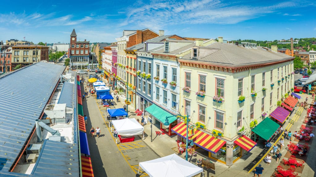Aerial view of colorful houses at Findlay market in the re-gentrified, up and coming neighborhood Over the Rhine in Cincinnati Ohio USA with street vendors on a sunny summer morning