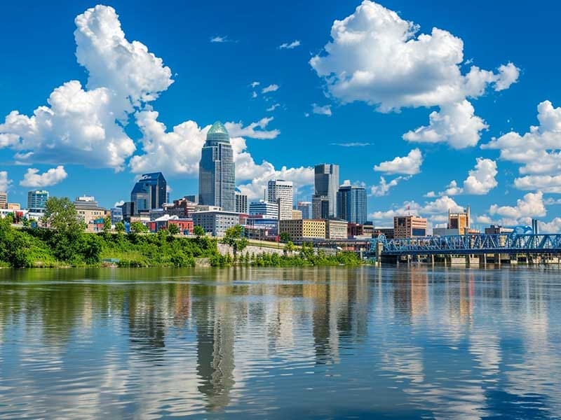 The skyline of nashville, tennessee is reflected in a river.